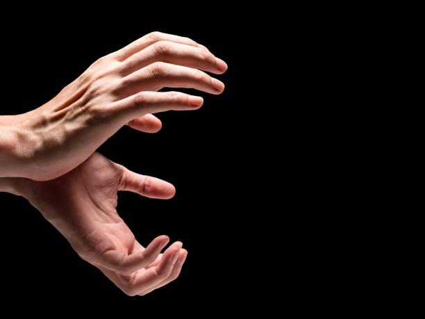 istock Male hands on a black background. Free space for text 845594990