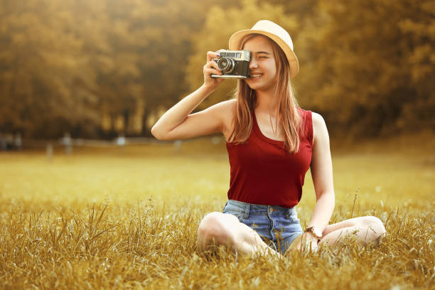istock cute girl with camera on grass autumn 845595180