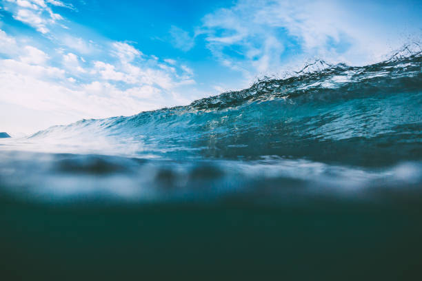 istock Crashing blue wave in ocean. Crystal wave and sun 845595226