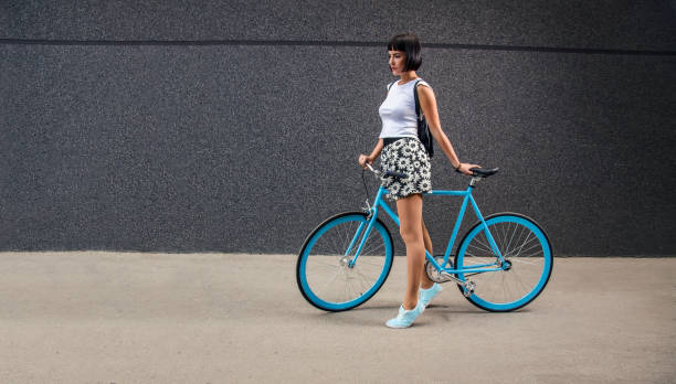 istock Urban hipster girl with all blue bicycle 845596392