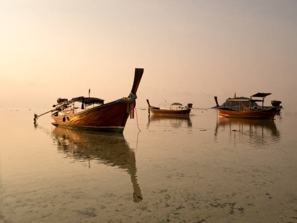 istock Local long tail boat in sea at sunrise when tide is falling or going out. Peaceful feeling at Lipe Island, Satun, Thailand. 845599322