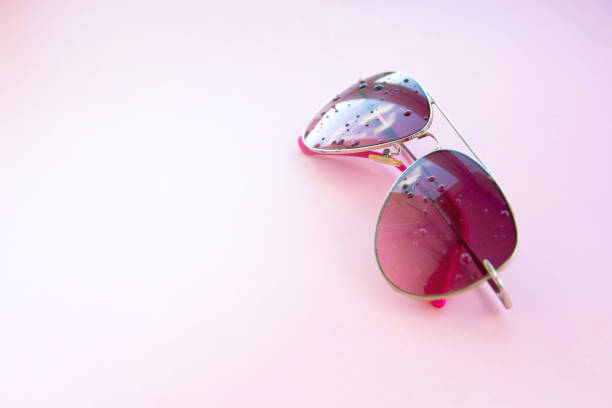 istock pink sunglasses on a pink background, with reflections, minimalist, copy space, style and design 845602570