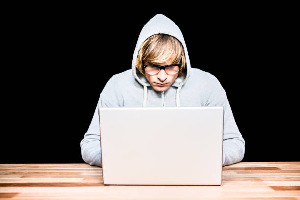 istock Man in hood jacket hacking a laptop 845606404