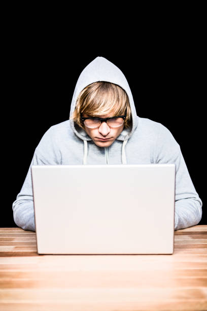istock Man in hood jacket hacking a laptop 845606444