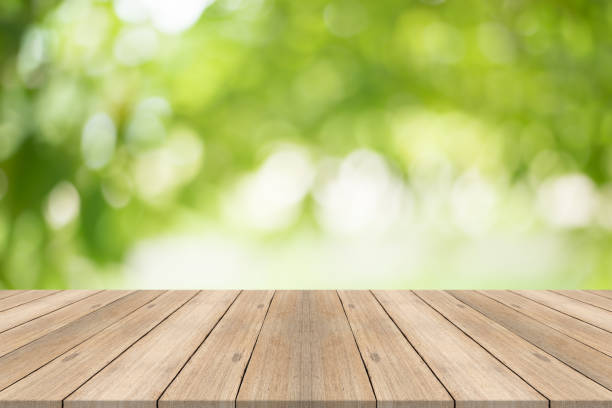 istock Empty wood table top on blurred abstract green background,Free space for editing products. 845608724