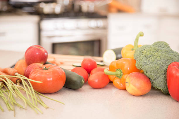Bowl with vegetables on wooden table in kitchen room with modern interior