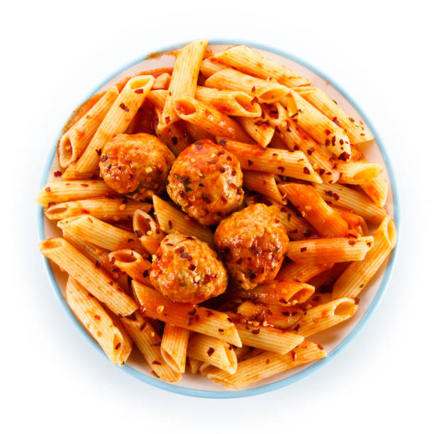 Pasta with meat, tomato sauce and vegetables Pasta with meat, tomato sauce and vegetables on white background penne meatballs stock pictures, royalty-free photos & images