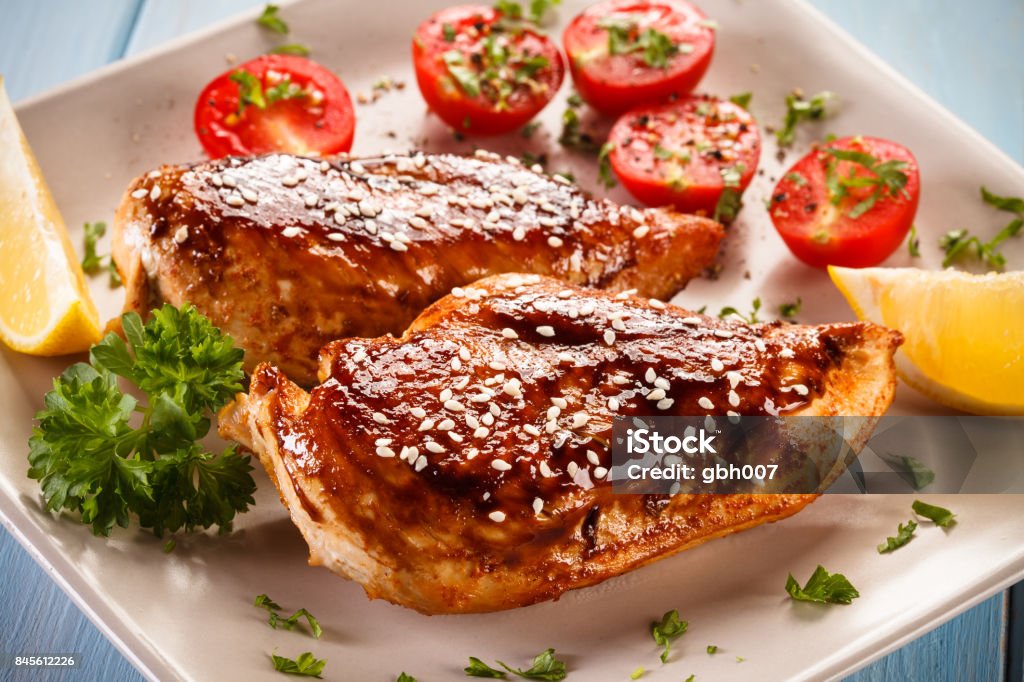 Grilled chicken breast and vegetables salad Grilled chicken breast and vegetables salad on white background Barbecue Chicken Stock Photo