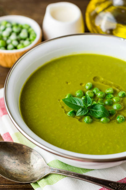 istock Green pea soup in bowl on wooden table 845612688