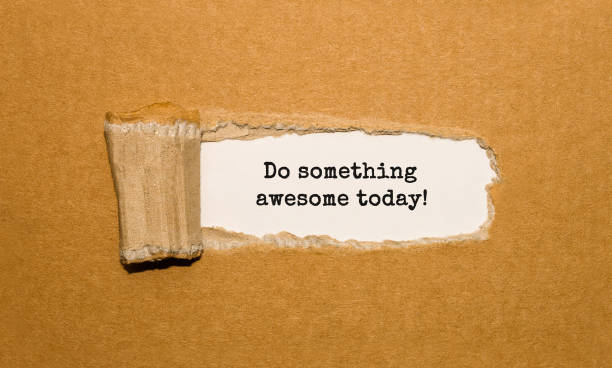 The text Do something awesome today appearing behind torn brown paper
