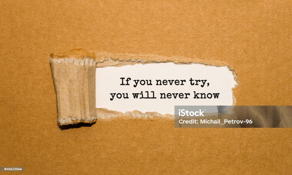 The text If you never try you will never know appearing behind torn brown paper Quotation - Text Stock Photo