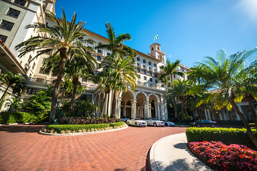 Palm Beach, Florida, USA - January 10, 2017: Entrance to the Historical Hotel The Breakers, first opened in 1896, few cars parked at the entrance, few people visible. The hotel complex is included to US National Register of Historic Places.