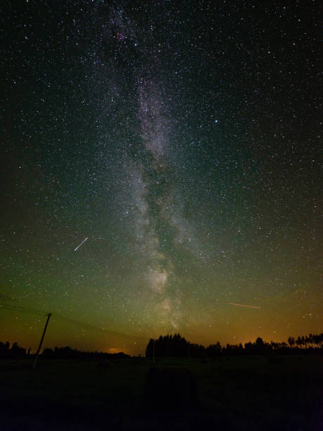 istock The Milky Way in night sky with stars and some trees. 845629668