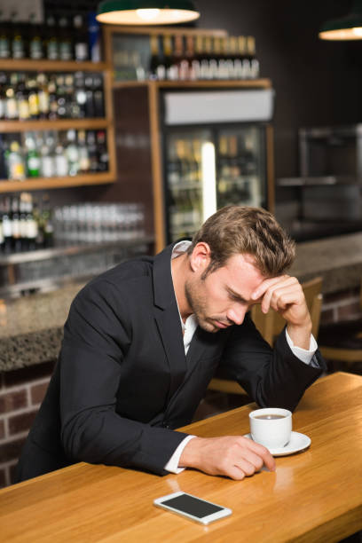 istock Handsome man looking at smartphone and having a coffee 845636562