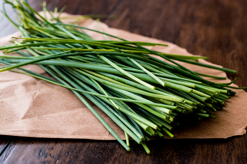 Fresh Chives / Siniklav or Frenk Sogani on wooden surface. Organic Concept.