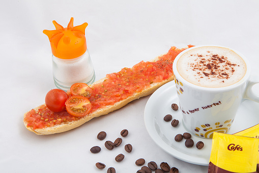 breakfast made of coffee with milk, toast with tomato