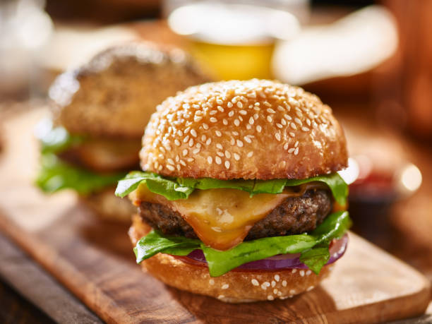 istock two burgers with sesame buns on rustic board 845639018