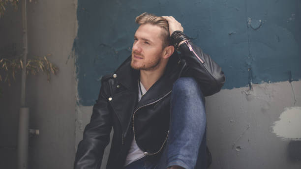 istock Gorgeous man sitting on the street 845639756