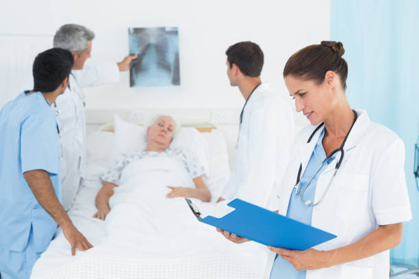 istock Report reading with colleagues and patient behind 845642824