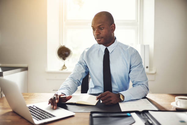 istock Focused young businessman working at his office desk 845649258
