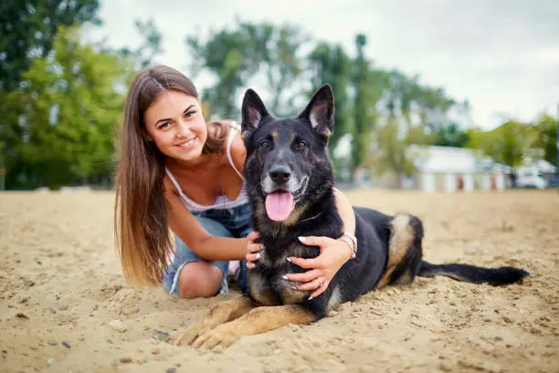Portrait of a girl with a dog by a German shepherd in the summer.