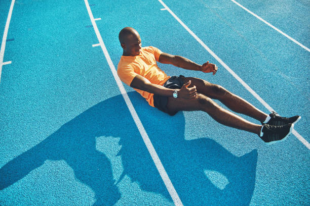 istock Fit young athlete doing crunches on a running track 845652690