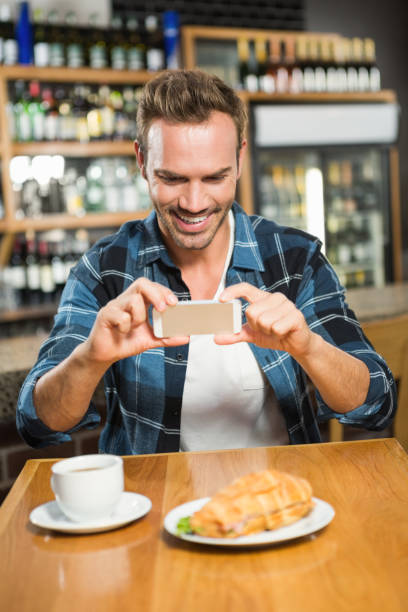 istock Handsome man taking a picture of his sandwich 845652868