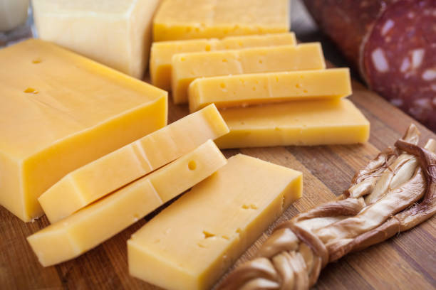 istock cheese and dairy products on a wooden board with eggs and sausage 845664072