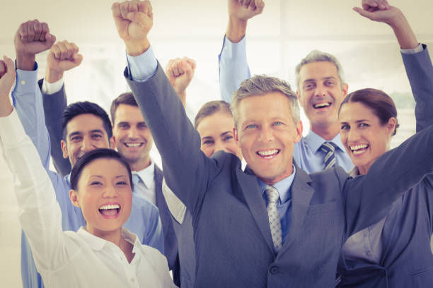 istock Business people cheering in office 845664086