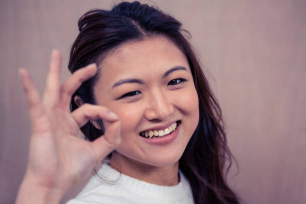 istock Smiling woman making ok sign with hand 845666348