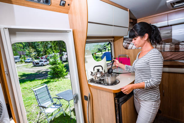 istock Woman cooking in camper, motorhome interior 845670278