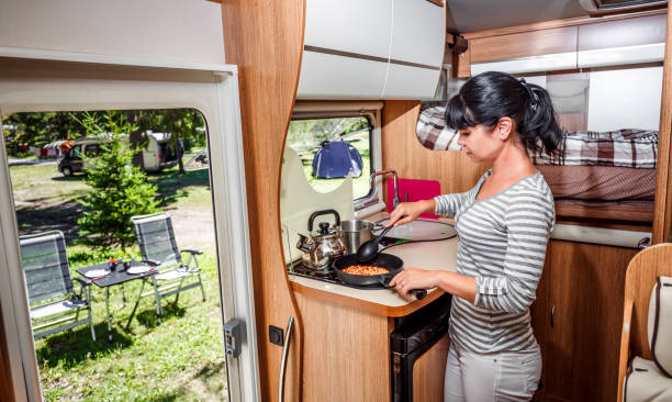 istock Woman cooking in camper, motorhome interior 845670310