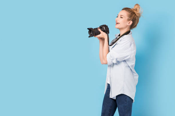 istock Young blonde photographer is taking a photo. 845681682