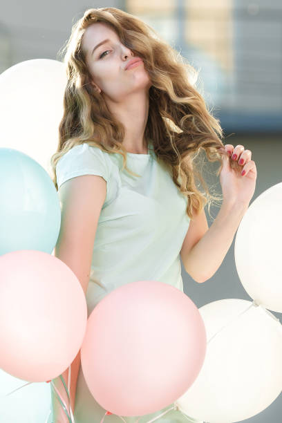 istock beautiful woman with flying multicolored balloons 845681744