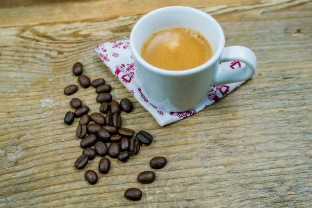 istock Coffee beans alongside a cup of milk coffee 845687670