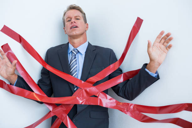 istock Businessman trapped by red tape 845687802