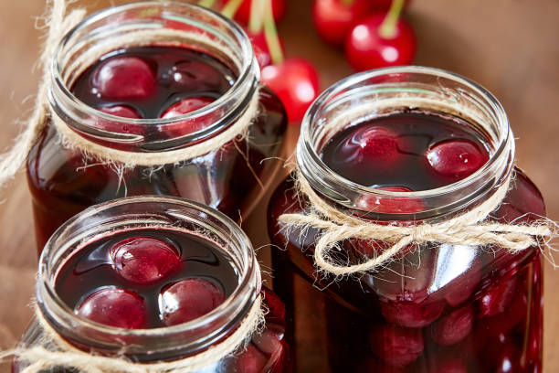 istock Cherry jam on wooden background in the jars 845687902