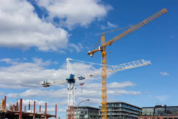 istock yellow and white crane on construction site with modern glass buildings 845687980