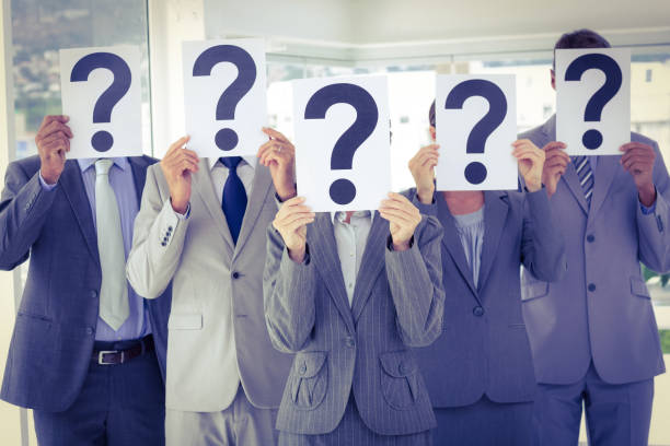 istock Business team holding question marks over face 845688188