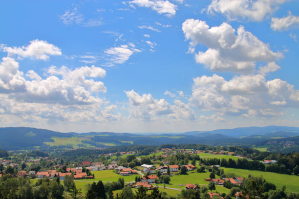 The picture was taken in Germany. The picture shows the hilly landscape of the countryside in Bavaria photographed on a cloudy day.