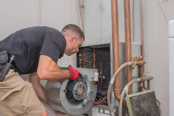 Hvac technician with Motor Hvac repair technician removing a blower motor from air handler electric motor stock pictures, royalty-free photos & images