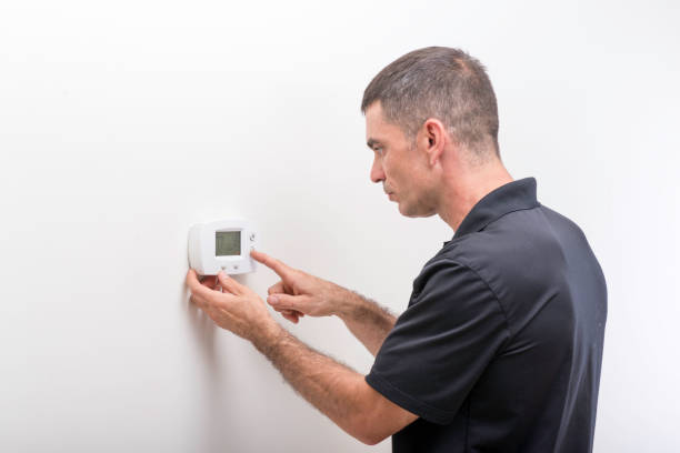 Adjusting Thermostat stock photo