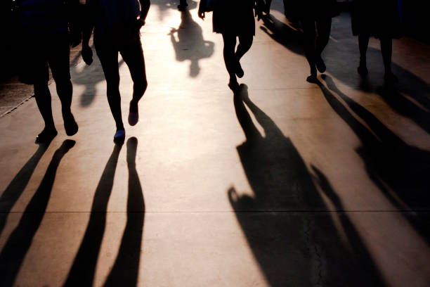 istock Blurry shadows of people walking on summer promenade 845696522