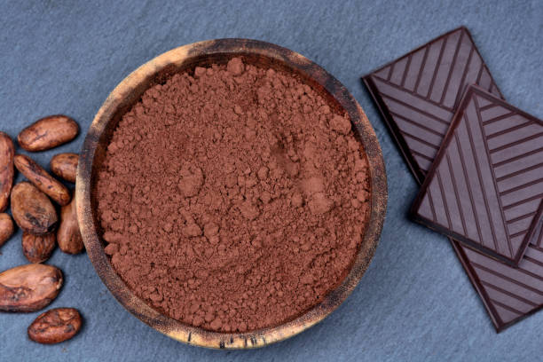istock Cacao powder in a bowl with beans and chocolate on slate 845696964