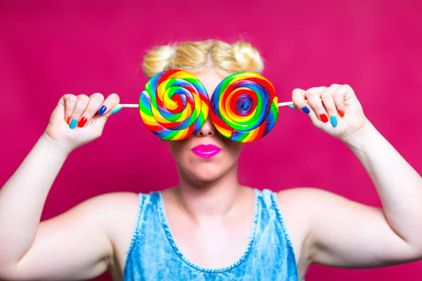 istock Blonde beauty with Lollipops in Hand 845697424