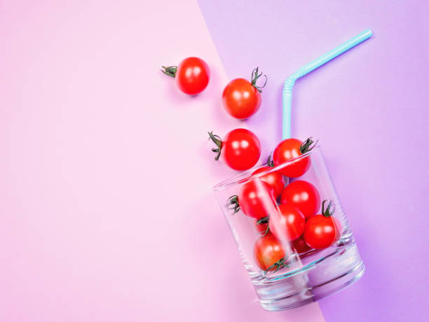 istock Tomato juice or smoothie, cherry tomato in drink glass with straw 845700044