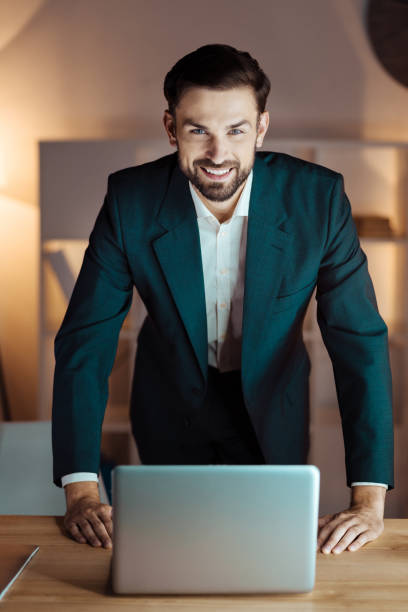 istock Positive manager standing in front of his computer 845702600