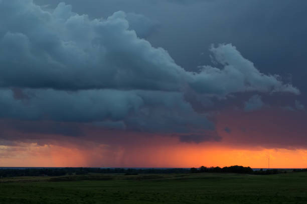 istock storm clouds over the field at sunset 845702928