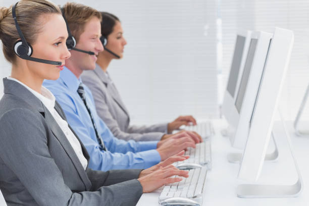 istock Business team working on computers and wearing headsets 845704138