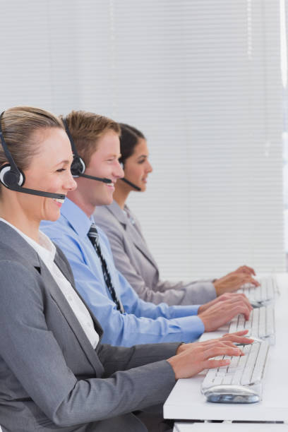 istock Business team working on computers and wearing headsets 845704154